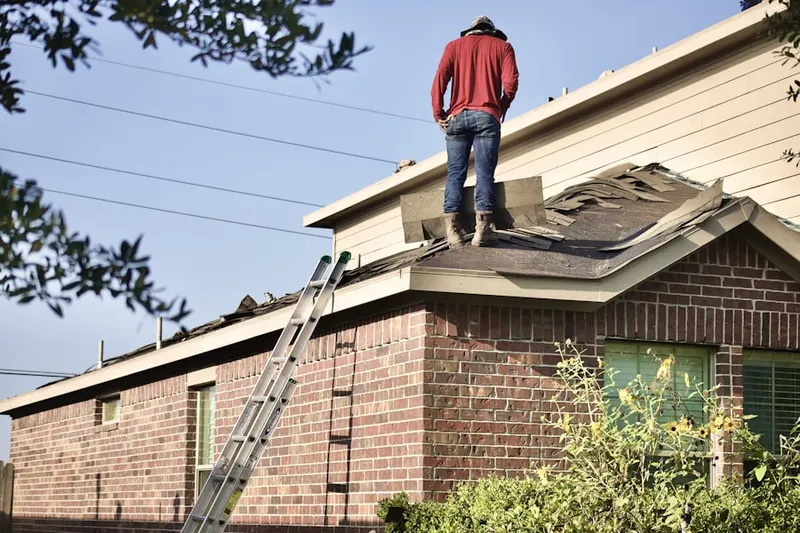 Professional roofer working on a residential roof in Mayer